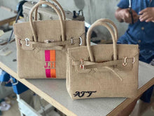 Afbeelding in Gallery-weergave laden, Travellers Hat Boutique Burlap O'Kelly handbag tote bags with personalized embroidery on a worktable