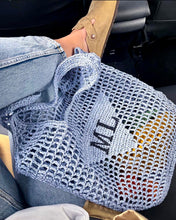 Cargar imagen en el visor de la galería, Handmade raffia bucket bag tote bag in light blue worn with casual outfit inside car