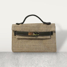 Load image into Gallery viewer, Wholesale jute clutch bags by Travellers Hat Boutique with black handle and metal clasp closure