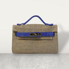 Load image into Gallery viewer, Wholesale jute clutch bags with blue faux leather handle and clasp by Travellers Hat Boutique
