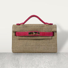 Load image into Gallery viewer, Wholesale jute clutch bags with pink leather handle and buckle detail by Travellers Hat Boutique