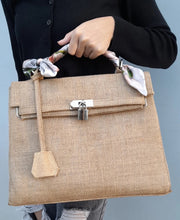 Afbeelding in Gallery-weergave laden, Burlap O'Kelly handbag tote bag by Travellers Hat Boutique with scarf-wrapped handle and lock detail