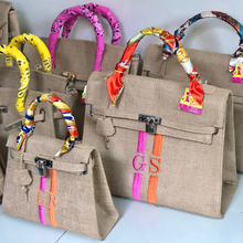 Afbeelding in Gallery-weergave laden, Burlap O'Kelly handbag collection by Travellers Hat Boutique with colorful scarf-wrapped handles and embroidered stripes