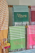 Load image into Gallery viewer, Personalized beach towel with custom name embroidery hanging among other striped towels