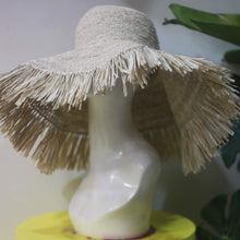 Load image into Gallery viewer, Beige raffia crochet sun hat with wide brim and fringed edges displayed on a mannequin head