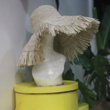 Load image into Gallery viewer, Beige raffia crochet sun hat with wide fringed brim on mannequin head at Travellers Hat Boutique