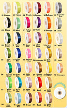 Carica l'immagine nel visualizzatore di Gallery, Color swatch chart with various ribbons in different colors on a yellow background
