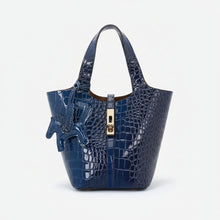 Carregar imagem no visualizador da galeria, Blue crocodile-patterned handbag with a gold zipper on a white background
