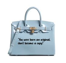 Carregar imagem no visualizador da galeria, Light blue leather personalized Beachkin tote bag with top handles and gold-tone lock from Travellers Hat Boutique
