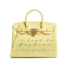 Carregar imagem no visualizador da galeria, Yellow personalized Beachkin tote bag with black script text and gold lock detail
