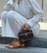 Load image into Gallery viewer, Custom square denim purse with brown leather accents held by woman wearing white outfit and brown sandals
