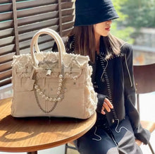 Load image into Gallery viewer, Denim blue jeans handbag tote bag with pearl and chain details by Travellers Hat Boutique on wooden table
