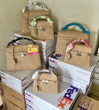 Load image into Gallery viewer, Set of eco friendly kelly style tote bags with colorful handles displayed on FedEx shipping boxes
