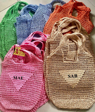 Carregar imagem no visualizador da galeria, Handmade raffia bucket bag in various colors including pink, natural, green, blue, and orange from Travellers Hat Boutique
