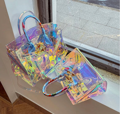 Travellers Hat Boutique holographic clear tote bag with colorful handles displayed on windowsill