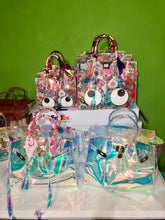 Carregar imagem no visualizador da galeria, Travellers Hat Boutique holographic clear tote bag collection with colorful and clear designs
