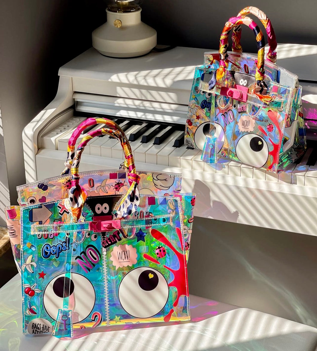 Travelers Hat Boutique holographic clear tote bag with colorful eye theme designs and wrapped handles
