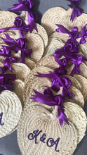Load image into Gallery viewer, Personalized embroidered abaniko fan with purple ribbons displayed in a group from Travellers Hat Boutique
