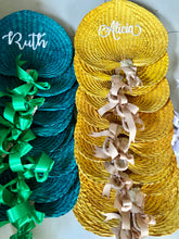 Load image into Gallery viewer, Stack of personalized embroidered abaniko fan in teal and yellow with ribbon accents from Travellers Hat Boutique

