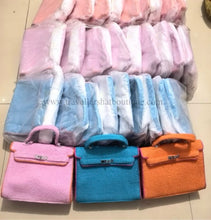 Cargar imagen en el visor de la galería, Terry cloth handbag tote bags in pink blue and orange by Travellers Hat Boutique stacked and wrapped in plastic
