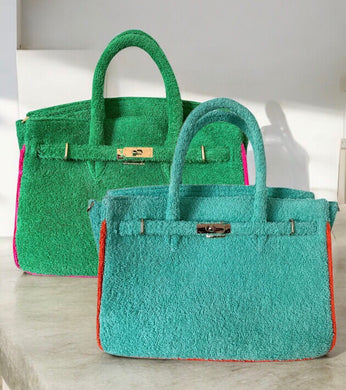 Two colorful terry tote bags wholesale featuring green and teal designs with sturdy handles and metal clasps