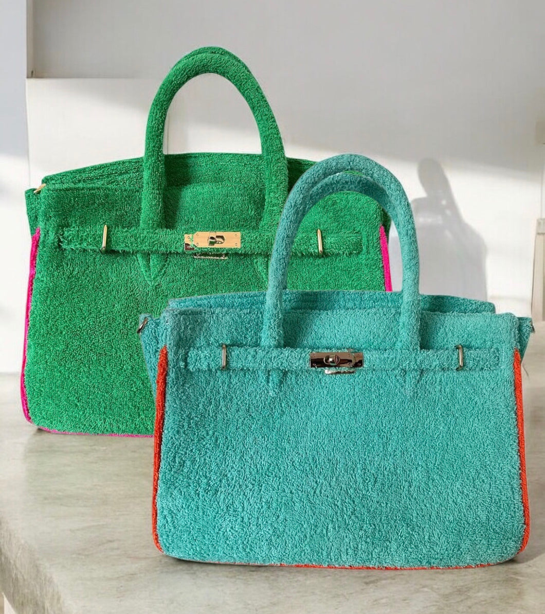 Two colorful terry tote bags wholesale featuring green and teal designs with sturdy handles and metal clasps