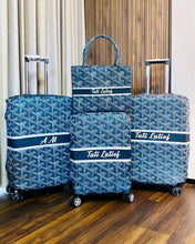 Load image into Gallery viewer, Travel luggage cover with name Tati Latief and initials AM on blue patterned suitcases and tote bag
