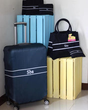 Load image into Gallery viewer, Travel luggage cover with name Sba on black suitcase cover and matching tote bag from Travellers Hat Boutique
