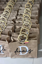 Load image into Gallery viewer, Travellers Hat Boutique personalized jute totes with bamboo handles and custom printed names
