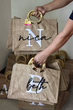 Load image into Gallery viewer, Personalized jute totes with bamboo handles from Travellers Hat Boutique featuring names and initials
