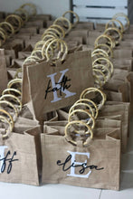Load image into Gallery viewer, Personalized totes with wooden handles featuring names and initials from Travellers Hat Boutique
