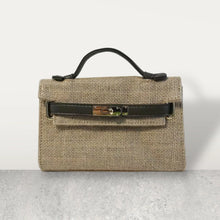 Load image into Gallery viewer, Wholesale jute clutch bags by Travellers Hat Boutique with black handle and metal clasp closure
