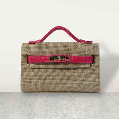 Wholesale jute clutch bags with pink leather handle and buckle detail by Travellers Hat Boutique