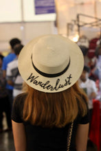 Carregar imagem no visualizador da galeria, Custom embroidered round hat from Travellers Hat Boutique with Wanderlust design worn by woman
