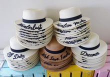 Carregar imagem no visualizador da galeria, Custom embroidered round hat collection by Travellers Hat Boutique with various text designs and colors

