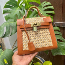 Load image into Gallery viewer, Handheld genuine leather solihiya bag tote with tan leather trim and woven rattan design
