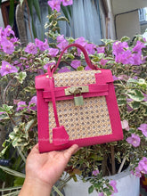 Load image into Gallery viewer, Pink genuine leather solihiya bag tote bag with top handle and gold lock held near purple flowers
