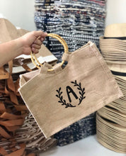 Load image into Gallery viewer, Beige tote bag with bamboo handles and black letter A embroidery from Travellers Hat Boutique
