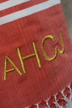 Load image into Gallery viewer, Personalized beach towel in red with gold embroidered initials and white striped edge from Travellers Hat Boutique
