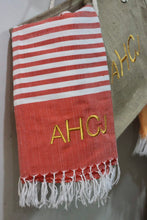 Load image into Gallery viewer, Personalized beach towel in red and white stripes with yellow embroidered initials and fringed edges
