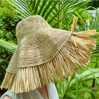 Stylish raffia crochet sun hat with wide brim and fringe detail perfect for sunny outdoor wear