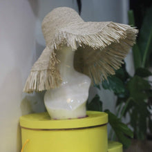 Carregar imagem no visualizador da galeria, Beige raffia crochet sun hat with wide fringed brim on mannequin head at Travellers Hat Boutique
