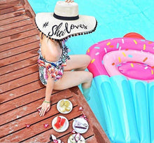 Lade das Bild in den Galerie-Viewer, Custom floppy hat with pompoms by Travellers Hat Boutique worn by woman sitting poolside
