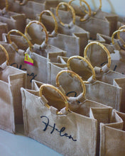 Load image into Gallery viewer, Natural jute totes with bamboo handles from Travellers Hat Boutique featuring personalized name design
