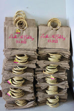Load image into Gallery viewer, Stack of personalized jute tote bags with bamboo handles for a 7th birthday party
