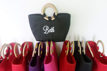 Load image into Gallery viewer, Personalized abaca tote bag in black with wooden handles and white embroidered name Beth
